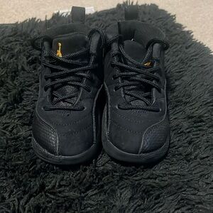 Jordan 12 black taxi kid shoes.